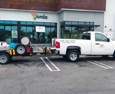 Crown Facility Solutions Truck hauling industrial cleaning machines