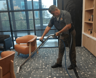 Crown Facility Solutions worker providing carpet cleaning services