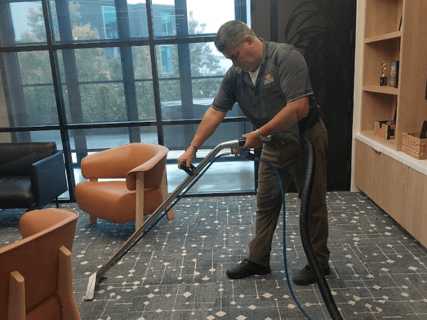 Crown Facility Solutions worker providing carpet cleaning services