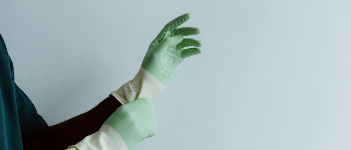 Person wearing gloves performing janitorial services