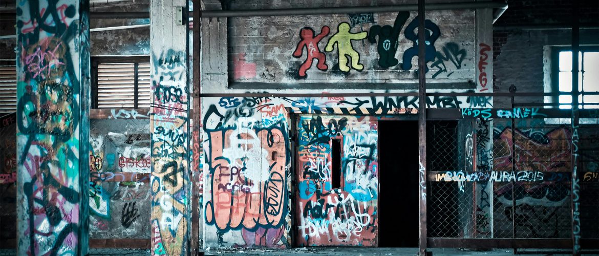 Image of graffiti on walls of industrial building tainting the professional look